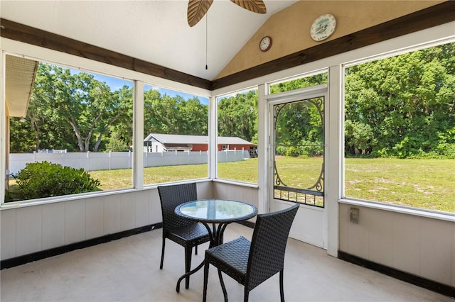 sunroom with plenty of natural light, ceiling fan, and lofted ceiling