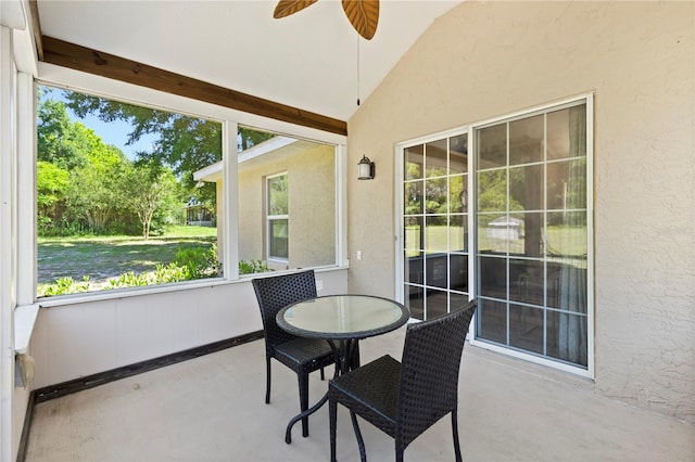 sunroom with a wealth of natural light, vaulted ceiling, and ceiling fan