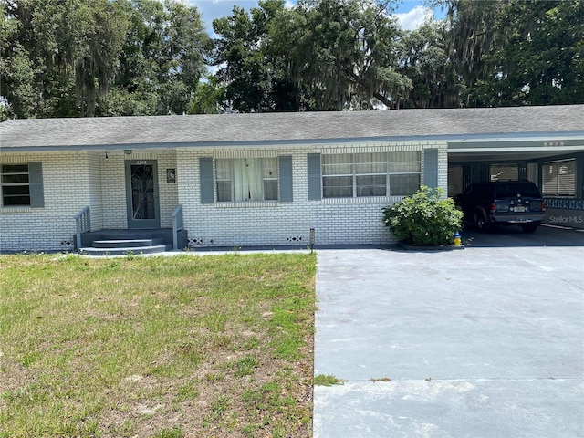 ranch-style home with a front lawn and a carport