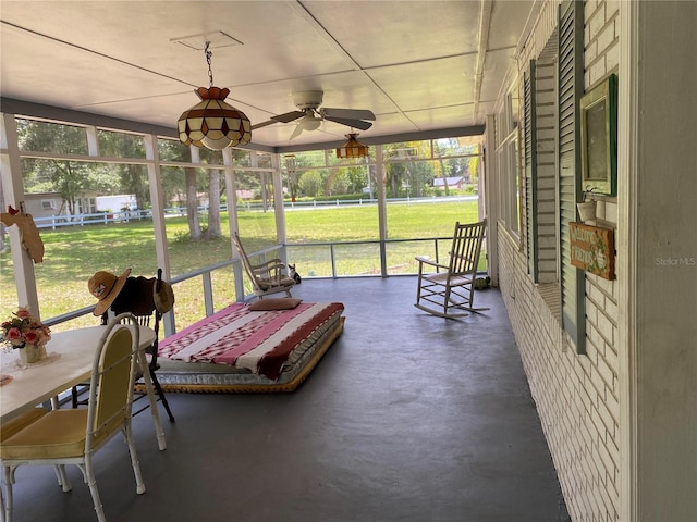 sunroom with plenty of natural light and ceiling fan