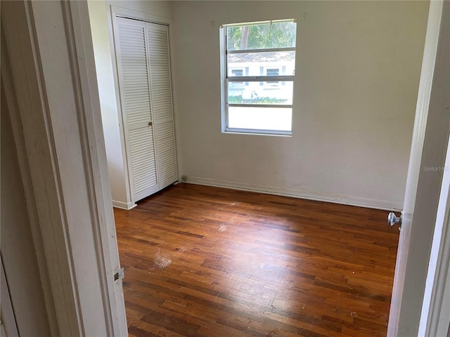 unfurnished bedroom featuring dark hardwood / wood-style flooring