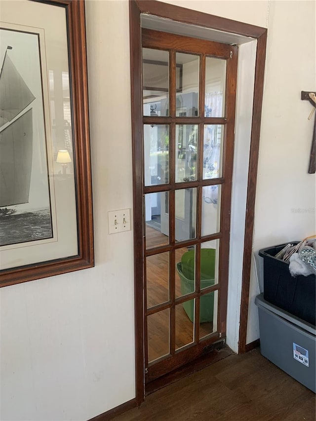 doorway with dark hardwood / wood-style flooring