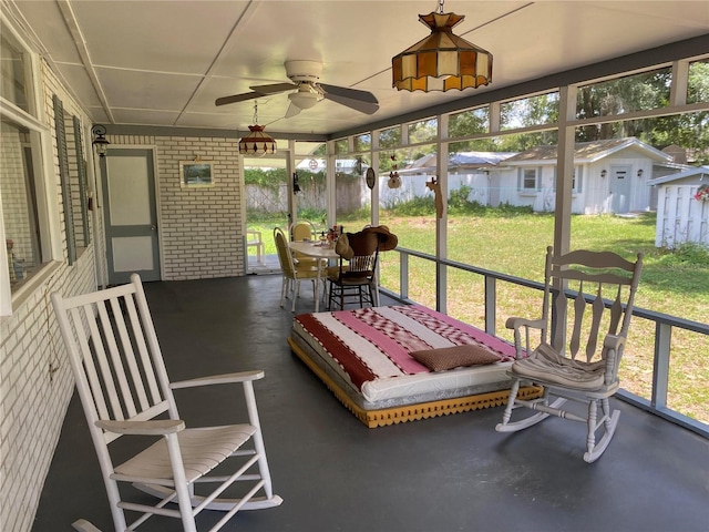 sunroom featuring ceiling fan and a healthy amount of sunlight