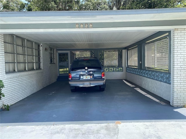 view of parking / parking lot featuring a carport