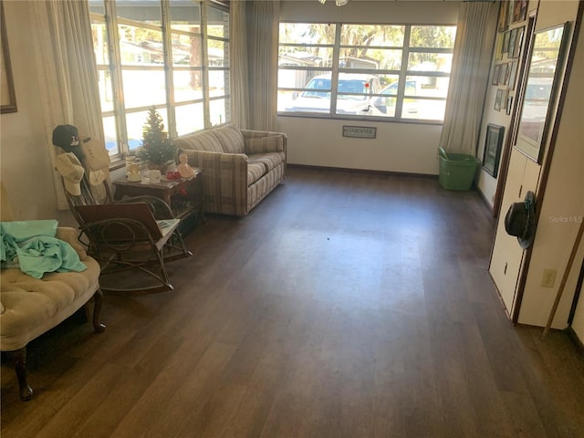 sitting room with dark wood-type flooring