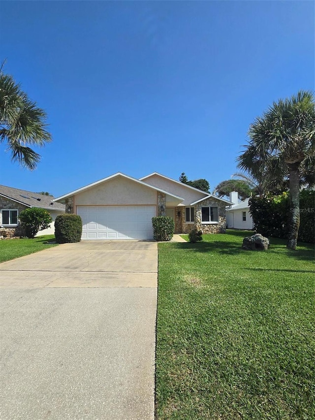 view of front of property featuring an attached garage, driveway, stone siding, and a front lawn