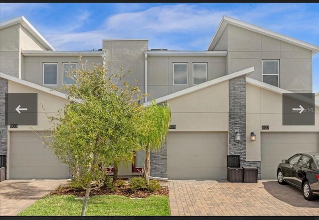 505 Ocean Course Ave Unit 505, Davenport, FL 33896 - contemporary house with stone siding, stucco siding, driveway, and an attached garage