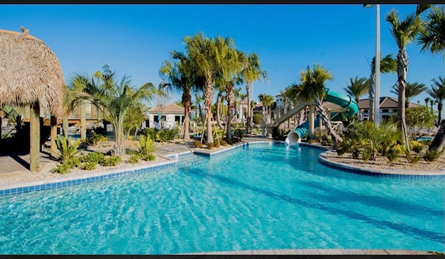 view of swimming pool with a water slide