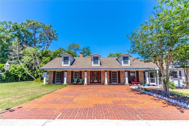 new england style home featuring a front yard