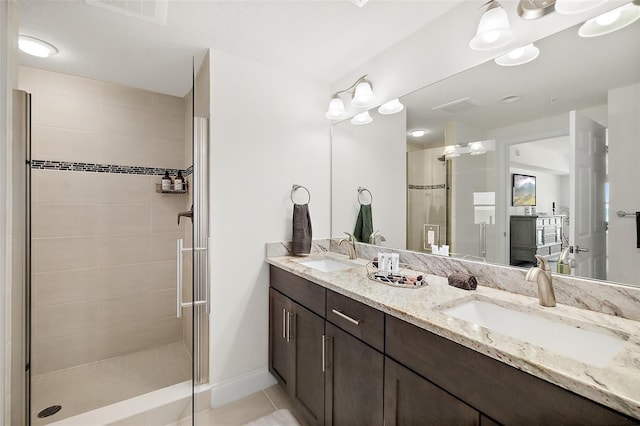 bathroom with tile patterned floors, vanity, and a shower with shower door