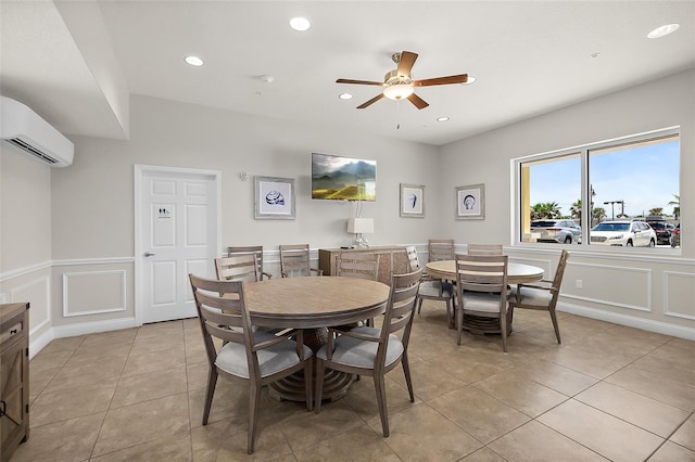 tiled dining area featuring ceiling fan and a wall mounted AC