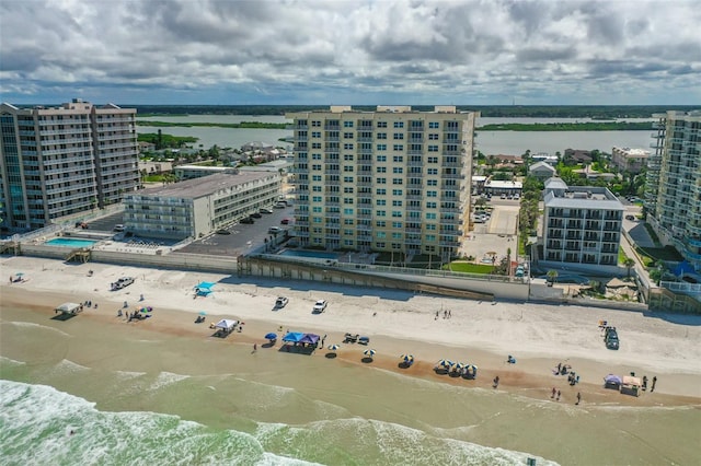 aerial view with a water view and a beach view