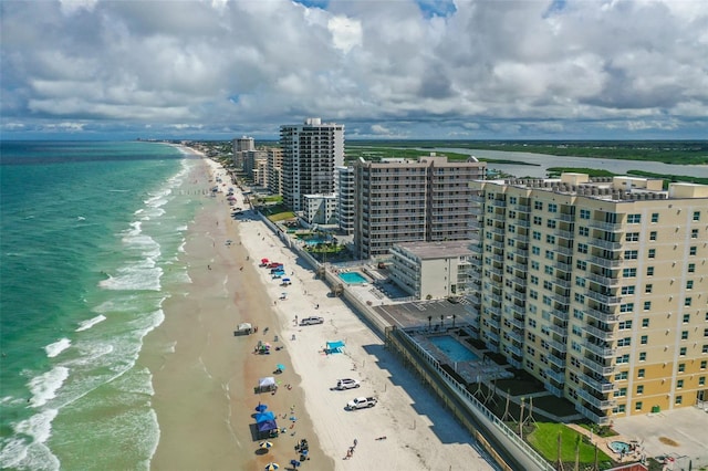 birds eye view of property featuring a water view and a beach view