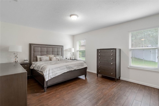 bedroom featuring dark hardwood / wood-style floors and a textured ceiling