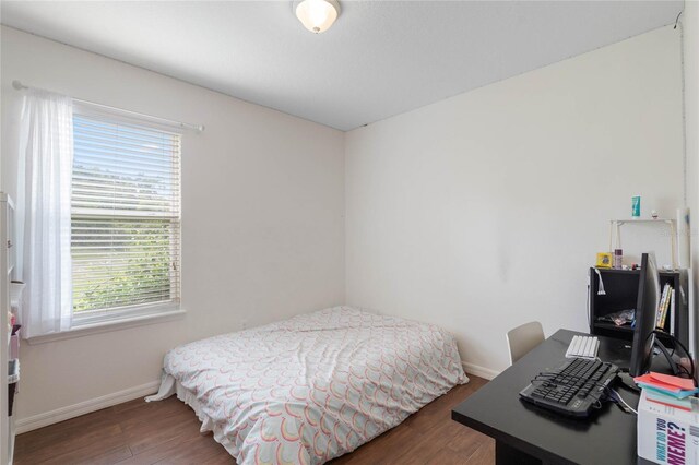 bedroom featuring dark wood-type flooring