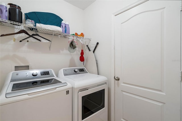 clothes washing area featuring washer and dryer