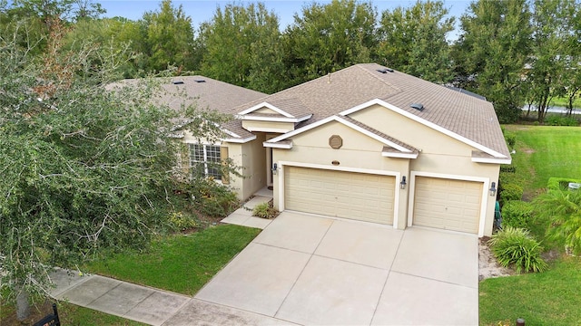 view of front of house with a front yard and a garage