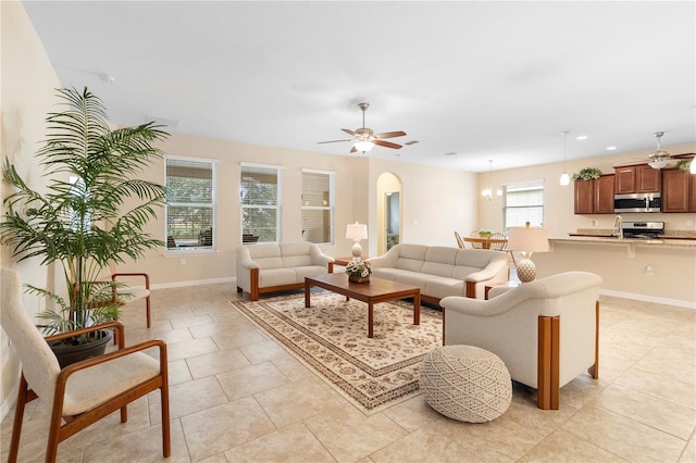 living room featuring sink, ceiling fan, and light tile patterned flooring