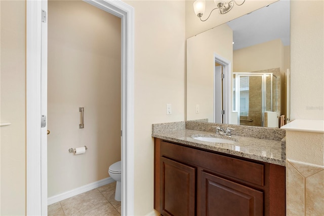 bathroom with tile patterned floors, vanity, toilet, and a shower with door