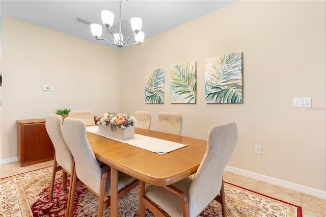 dining space featuring an inviting chandelier and light tile patterned flooring