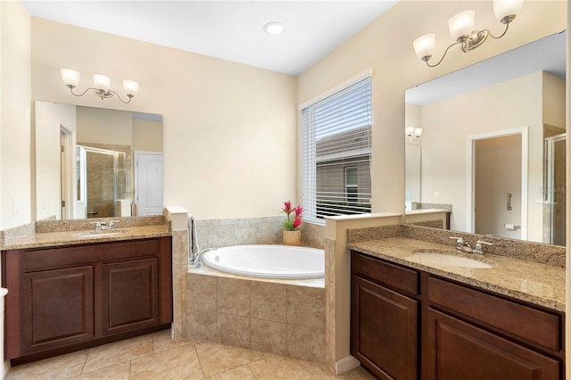 bathroom with tile patterned flooring, vanity, an inviting chandelier, and plus walk in shower