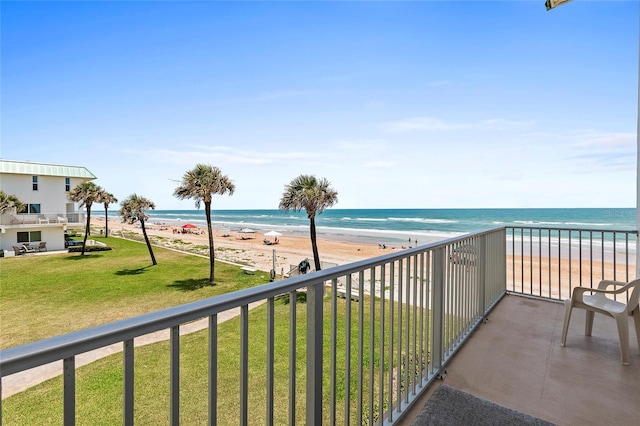 balcony featuring a water view and a beach view