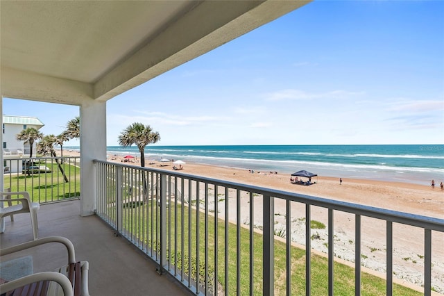 balcony featuring a beach view and a water view