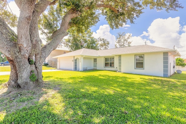 single story home with a garage and a front lawn