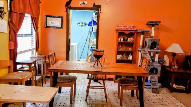 carpeted dining area featuring washer / dryer