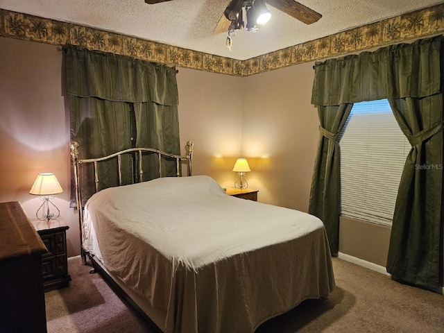 bedroom featuring ceiling fan, dark carpet, and a textured ceiling