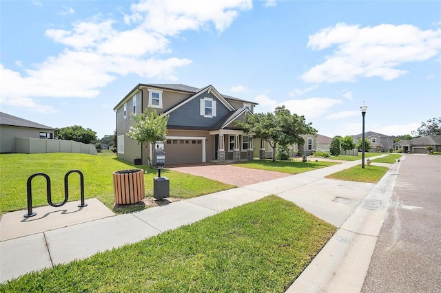 craftsman house with a front lawn and a garage