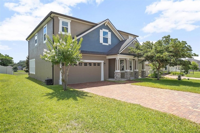 craftsman house with a garage, a front lawn, and central AC unit