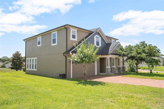 view of side of home featuring a lawn and central AC