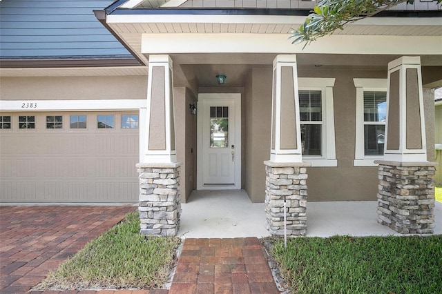 property entrance with a garage and a porch