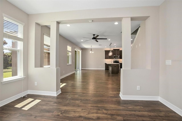 interior space featuring ceiling fan and dark wood-type flooring