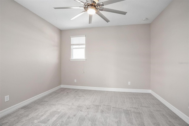 spare room featuring ceiling fan and light carpet