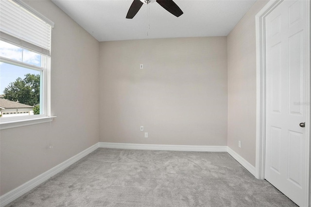 empty room featuring light carpet and ceiling fan