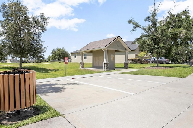 view of home's community with basketball court and a yard