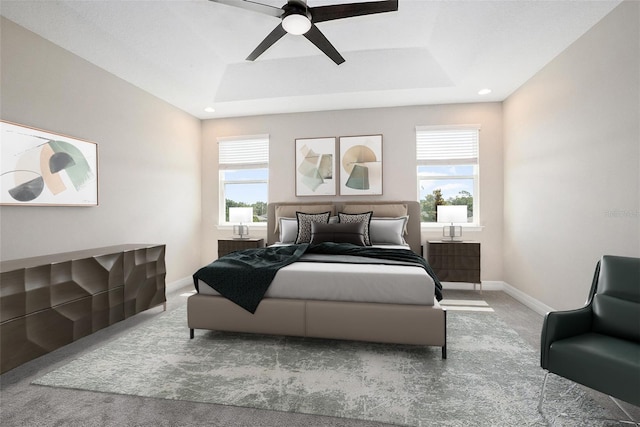 bedroom featuring ceiling fan, carpet flooring, and a raised ceiling