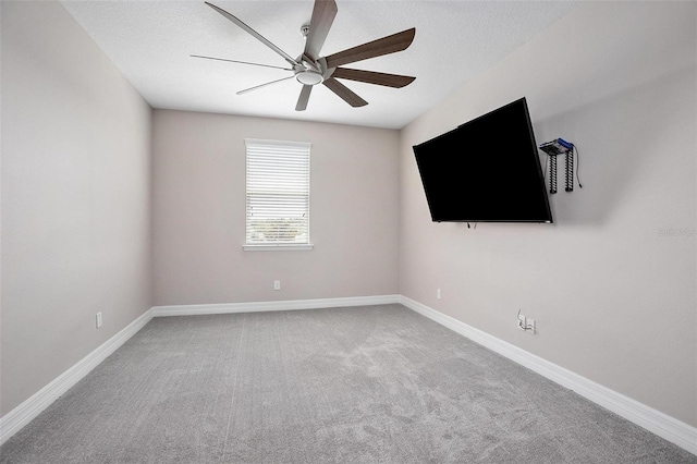 empty room with ceiling fan and carpet