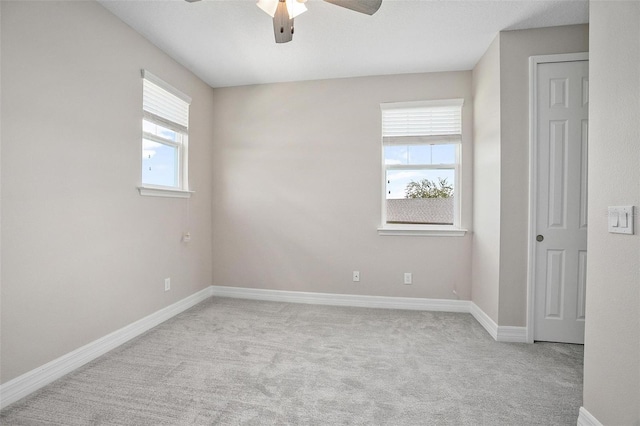 spare room featuring ceiling fan and light colored carpet