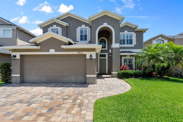 front facade featuring a garage and a front yard