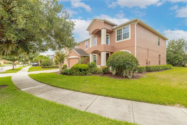 view of front of house with a garage and a front yard