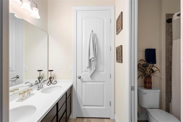 bathroom with vanity, toilet, and wood-type flooring