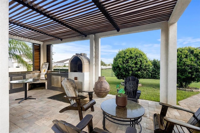 view of patio / terrace with an outdoor kitchen and a pergola