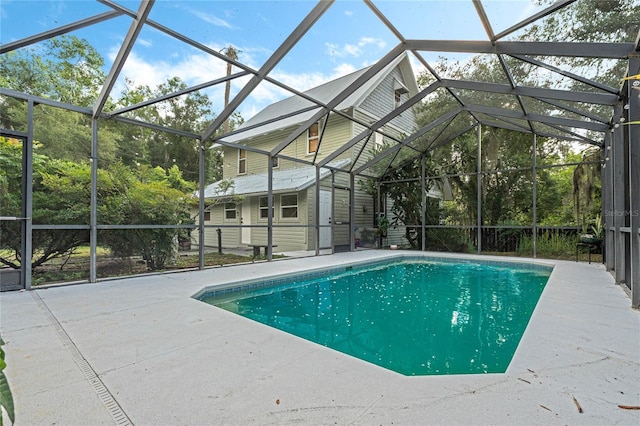 view of swimming pool featuring a patio and a lanai