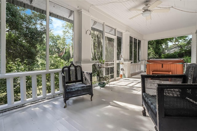 sunroom / solarium featuring ceiling fan