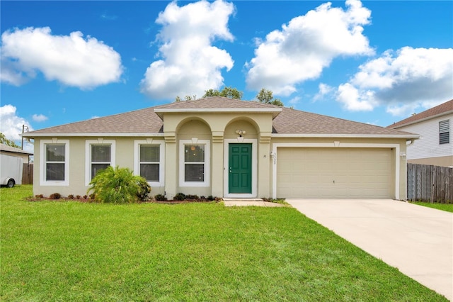 mediterranean / spanish house featuring a garage and a front lawn