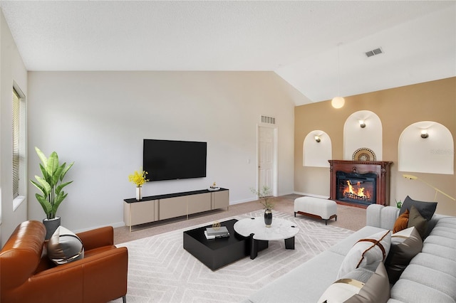 carpeted living room featuring lofted ceiling