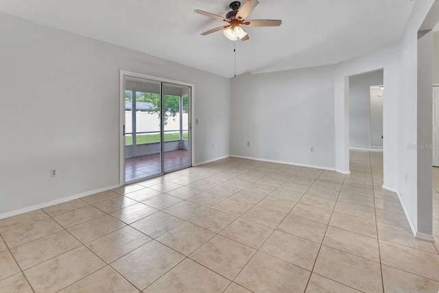 tiled spare room featuring ceiling fan